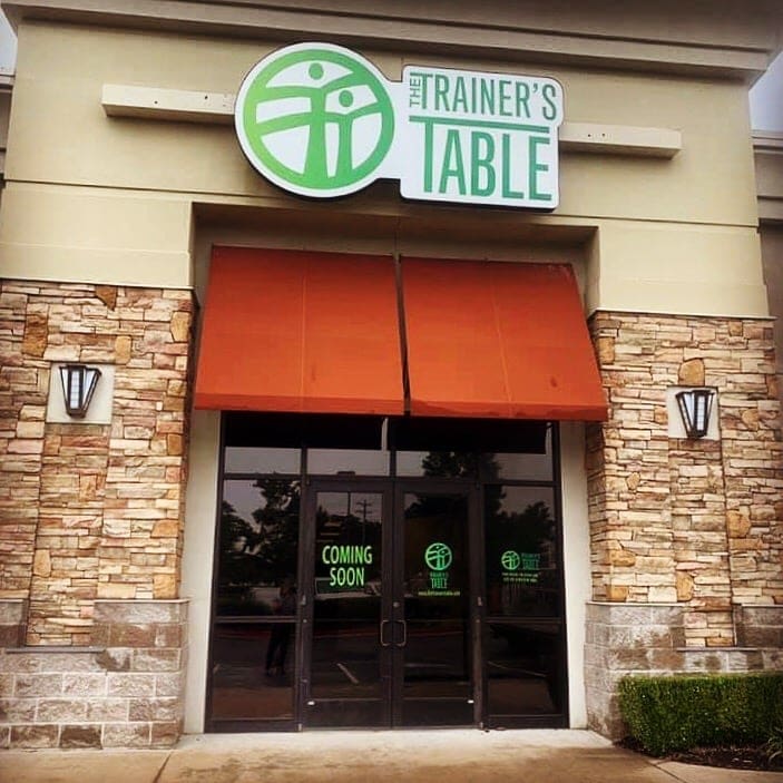 The Trainer's Table 6 outside view of business displaying bold green logos